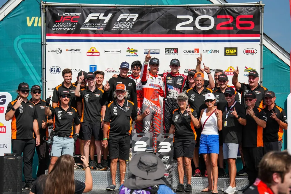 The Crosslink Motorsports crew and drivers celebrating on the podium